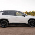 Side profile shot of a white 2021 Toyota RAV4 Hybrid XSE