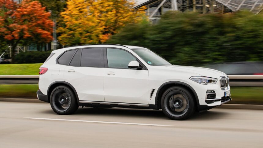 Side profile shot of a white 2021 BMW X5 PHEV