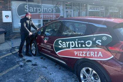 here is a driver getting into an electric delivery car with the Sarpino