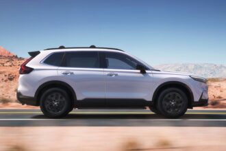 Side profile shot of a white 2025 Honda CR-V Hybrid Sport